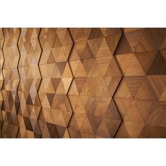 a wall made out of wood with many different shapes and sizes on the side,