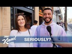 a man and woman standing next to each other in front of a building with the words seriously?