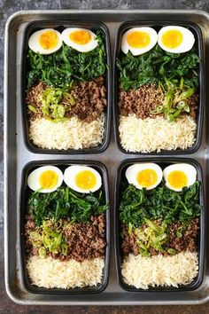 four trays filled with rice, meat and eggs on top of each other next to broccoli