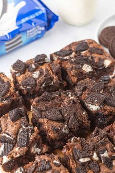 cookies and oreo cookie bars on a plate next to milk