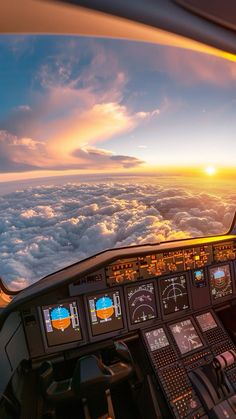 an airplane cockpit with the sun setting in the distance and clouds visible from it's windows