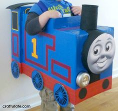 a toddler in a thomas the tank engine costume