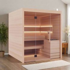 an empty sauna in the middle of a room with wooden shelves and drawers on each side