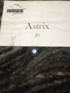 an asterx sign on the side of a granite counter top in a store