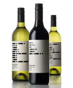 three bottles of wine sitting next to each other on a white surface with reflective surfaces