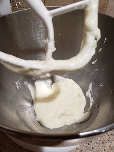 a metal bowl filled with batter on top of a counter