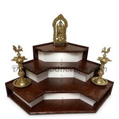 three tiered wooden shelf with golden statues on top and bottom shelves in the shape of hexagonal boxes