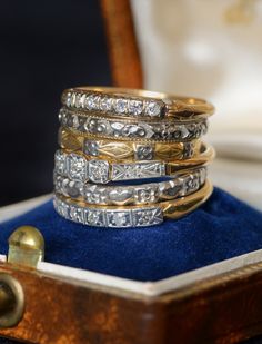 a stack of rings sitting on top of a blue velvet box