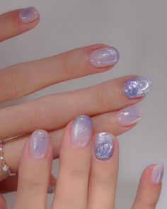 a woman's hands with pink and purple manies