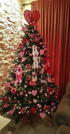 a decorated christmas tree with pink and red decorations