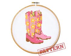 a cross stitch pattern with a pink cowboy boot on it's side and the word,