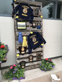 the display is made out of old pallets and used as a coat rack for sports memorabilia