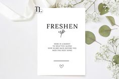 a white card with the words freshen up on it next to some baby's breath flowers