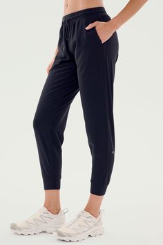 A person is shown wearing SPLITS59's Classic Airweight Jogger in Black and white athletic shoes. The focus is on the side view of the lower body, perfect for a workout. Fitted Joggers, Black Xs, Sport Pants, Tapered Legs, Active Wear For Women, Active Wear, Casual Wear, Sweatpants, Relaxed Fit