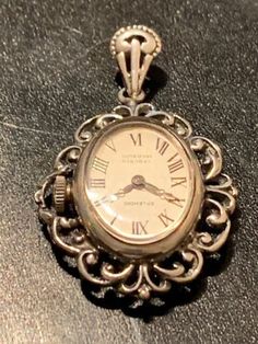 Vintage watch pendant necklace. Mechanical hand winding watch. Perfect time keeping. The watch is marked 835 silver ( standard for Switzerland and Germany( The chain is marked 925, for sterling silver. This pendant watch is from the 1960's but represents the style of art nouveau from the 1900's. I have tested the watch time keeping and it works perfectly well. Will be sent by registered and insured post free of charge. For countries outside of the EU, import charges may apply! Watch Pendant, Pendant Watch, Mechanical Hand, Pendant Watches, Onyx Necklace, Pearl Brooch, Style Art, Vintage Watches, Sterling Silber