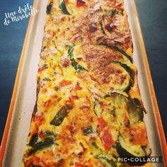 a casserole dish with zucchini and peppers in it on an orange tray