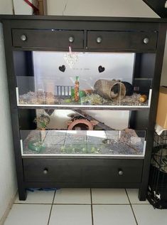 a fish tank sitting on top of a wooden shelf