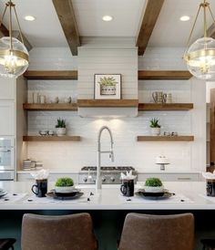 the kitchen is clean and ready to be used for cooking or eating, with two chairs at the counter