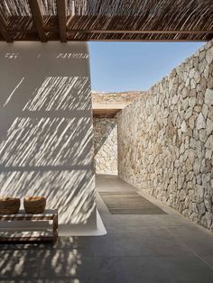 an outdoor area with stone walls and benches