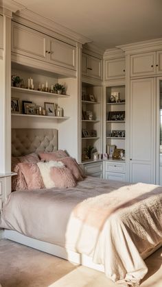 a large bed sitting in a bedroom next to a book shelf filled with lots of books