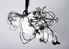 a bunch of wires that are attached to a light fixture in the shape of a robot