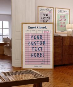 three posters on the wall in a room with wooden flooring and wood table top