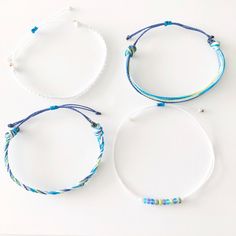 Adjustable Blue Friendship Bracelets For Vacation, White Adjustable Cord Friendship Bracelets For Beach, Adjustable Blue Strand Friendship Bracelet, Casual Beaded Bracelets With Sliding Knot For Vacation, White Braided Bracelets With Sliding Knot For Summer, Adjustable White Bracelets For Vacation, White Adjustable Bracelets For Vacation, White Friendship Bracelet With Sliding Knot For Summer, White Braided Bracelet With Sliding Knot For Summer