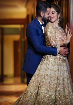 a man and woman hugging each other in front of a door