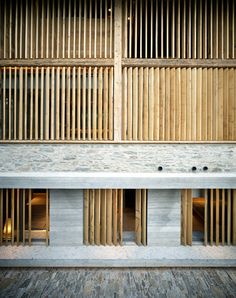 the inside of a building with wooden slats