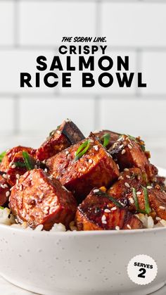 a bowl filled with rice and meat on top of a white table next to the words crispy salmon rice bowl