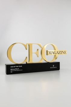 a black and gold award stand with the word'magazine'on it, in front of a white background