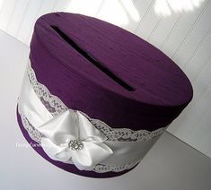 a purple hat with white lace and a bow