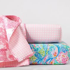 three different types of baby blankets are stacked on top of each other, one pink and the other blue