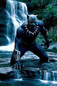 a man dressed as black panther standing in front of a waterfall with his hands on his hips