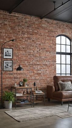 a living room with a brick wall and leather furniture in front of a large window