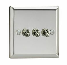 a chrome plate with three knobs and two switches on each side, in the same color