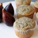 some muffins are sitting on a plate with figs