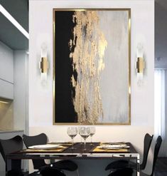 a dining room table with black chairs and a large painting on the wall above it