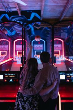 a man and woman standing in front of a basketball game