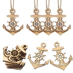 four different types of anchor and ship wheel charms on strings, all in gold tone