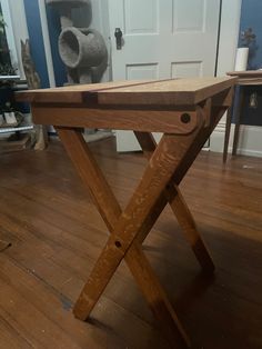 a wooden bench sitting on top of a hard wood floor