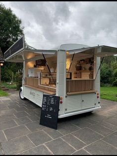 the food truck is parked on the side of the road