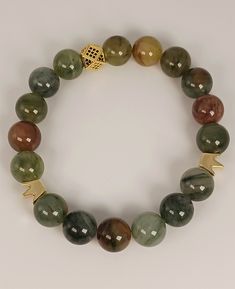 Colorful phantom agate beaded stretch cord bracelet with two gold tone crowns and a gold tone spacer. Bracelet fits wrist sizes 7-7.5 inches. Adjustable Gold Agate Stretch Bracelet, Cord Bracelet, Gold Crown, Kansas City Mo, Cord Bracelets, Beaded Stretch Bracelet, Agate Beads, Stretch Bracelet, Stretch Bracelets