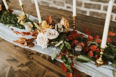 flowers and candles are arranged on a table