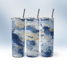 three tumblers with straws in them on a white background, one is blue and the other is gold