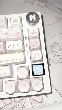 a white keyboard with pink and white designs on it