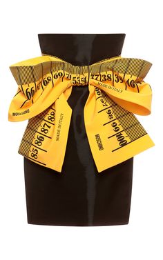 a woman wearing a black and yellow skirt with a large bow on the waist,