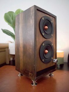 a wooden speaker sitting on top of a table