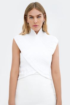 Do you believe in magic? Our Colette Bolero can instantly transform your look for day or night. This sleeveless vest has a high neck, ribbed detailing, and a contrast zipper at the back for a standout look. Crafted from luxe French organic cotton, she's designed to wrap around the torso in an elegant crisscross, elevating your go-to layering basic to something extraordinary. Need help putting it on? Watch the tutorial. [SPLIT] Yada, in key lime, is 5'9" (175 cm) tall, wearing size XS. Maritza, i Bolero Top, Tunic Hoodie, Believe In Magic, Do You Believe, Key Lime, Sleeveless Vest, Black Sleeveless, Tunic Dress, Wrap Around