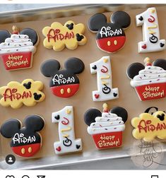 mickey mouse birthday cookies are arranged on a cookie sheet